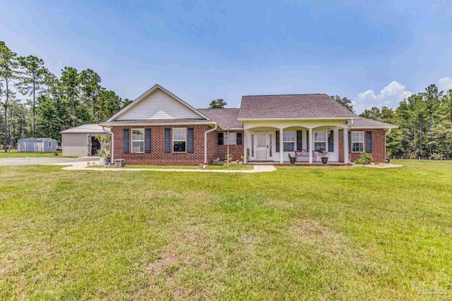 ranch-style home with a shed, a front lawn, and a porch