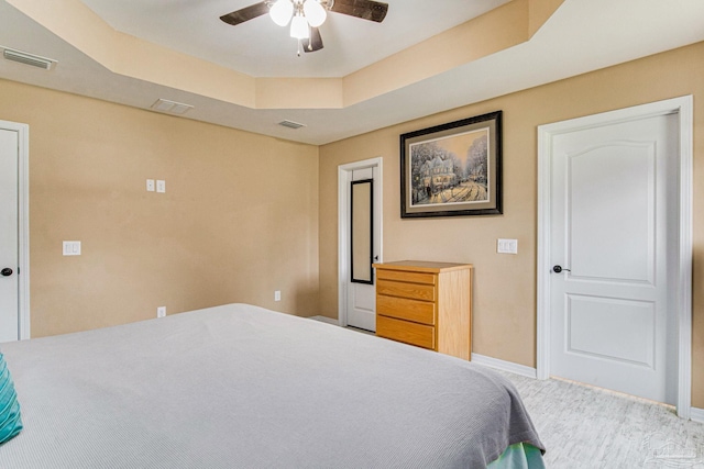 bedroom featuring a tray ceiling and ceiling fan