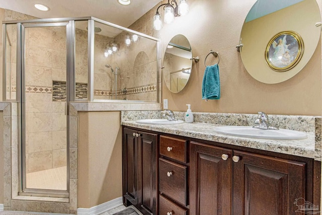 bathroom with vanity and a shower with door