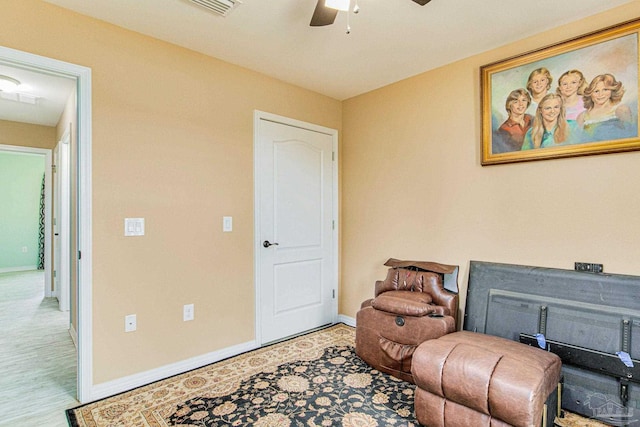 living area with ceiling fan