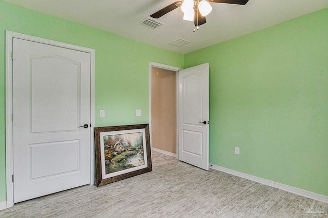 spare room featuring ceiling fan and light wood-type flooring