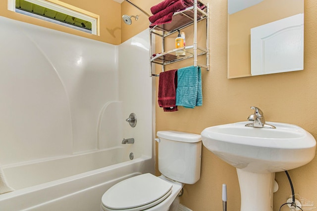 bathroom with tub / shower combination and toilet