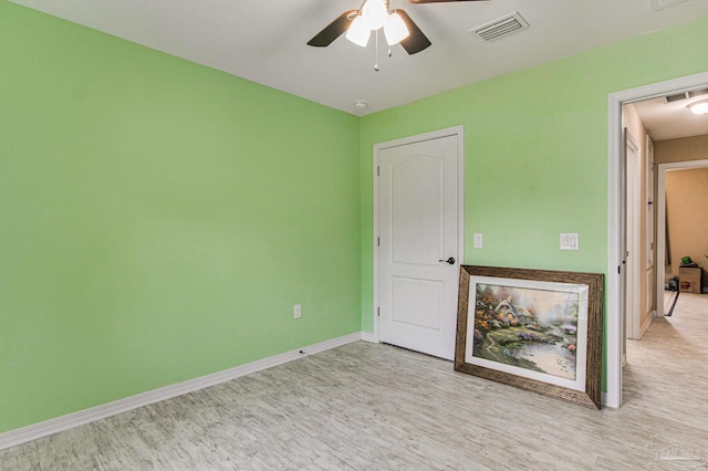 unfurnished room featuring ceiling fan and light wood-type flooring