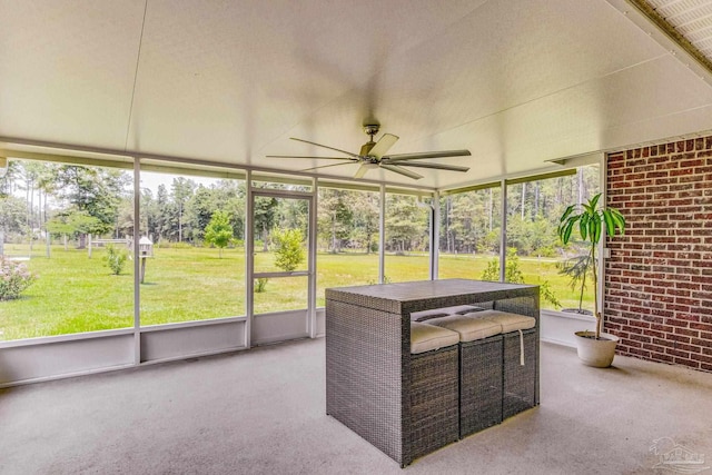 unfurnished sunroom featuring ceiling fan