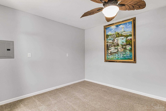 carpeted spare room featuring ceiling fan and electric panel