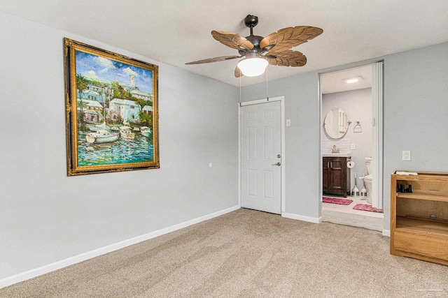 unfurnished bedroom featuring carpet floors, ceiling fan, and ensuite bathroom