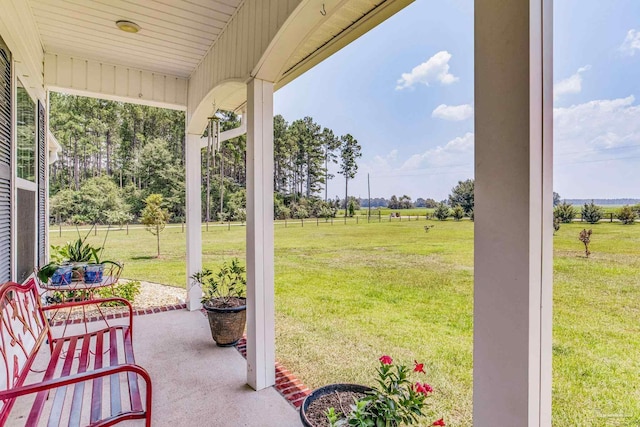 view of patio / terrace with a porch and a rural view