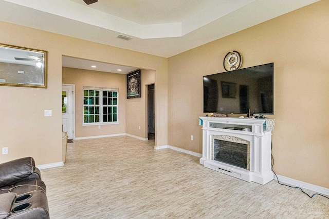 living room featuring ceiling fan and light hardwood / wood-style flooring