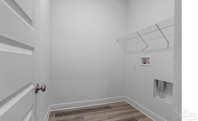 clothes washing area featuring baseboards, washer hookup, laundry area, and dark wood-style flooring