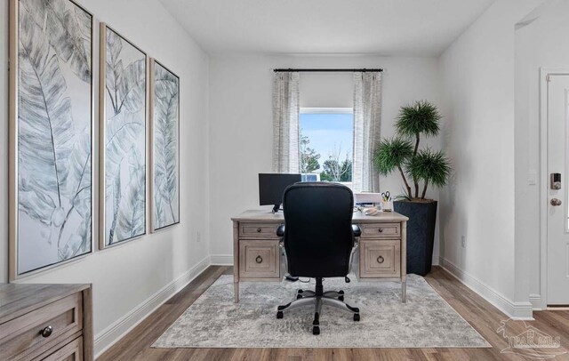 office area featuring baseboards and wood finished floors
