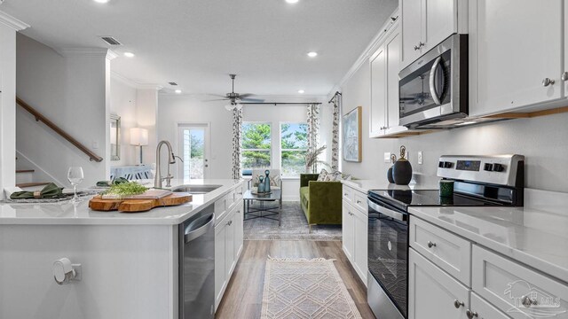 kitchen featuring light countertops, appliances with stainless steel finishes, visible vents, white cabinets, and ceiling fan