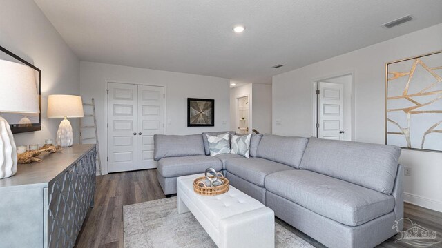 living room with dark wood finished floors, recessed lighting, and visible vents