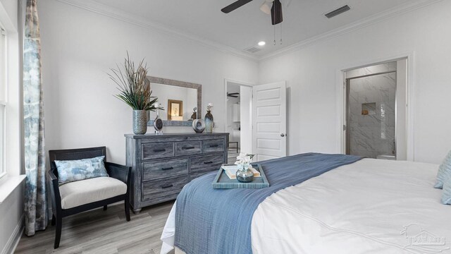 bedroom with visible vents, crown molding, baseboards, wood finished floors, and ensuite bath