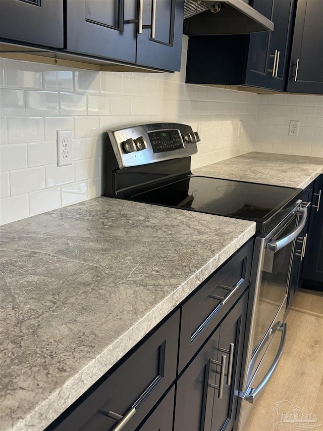 kitchen with tasteful backsplash, extractor fan, stainless steel electric range oven, and light hardwood / wood-style floors