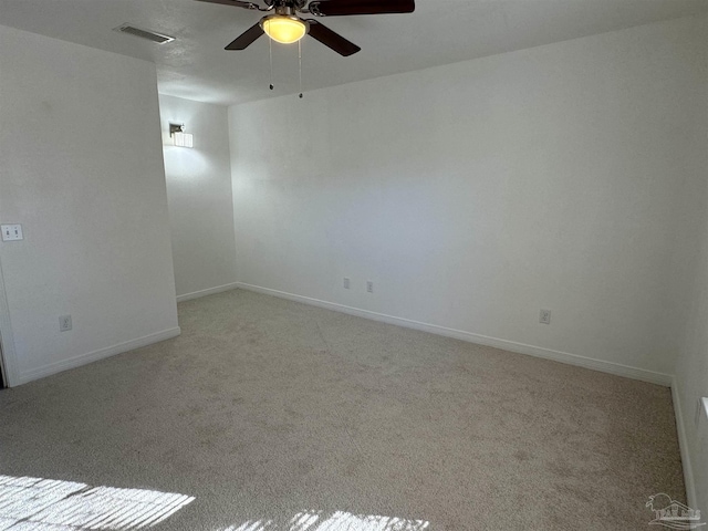 unfurnished room featuring ceiling fan and light carpet