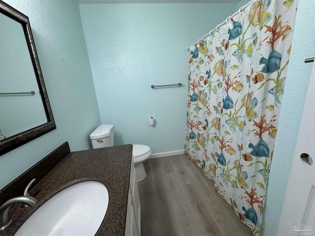 bathroom featuring hardwood / wood-style flooring, vanity, and toilet