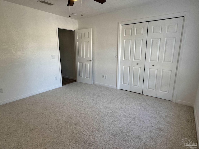 unfurnished bedroom featuring light carpet, a closet, and ceiling fan