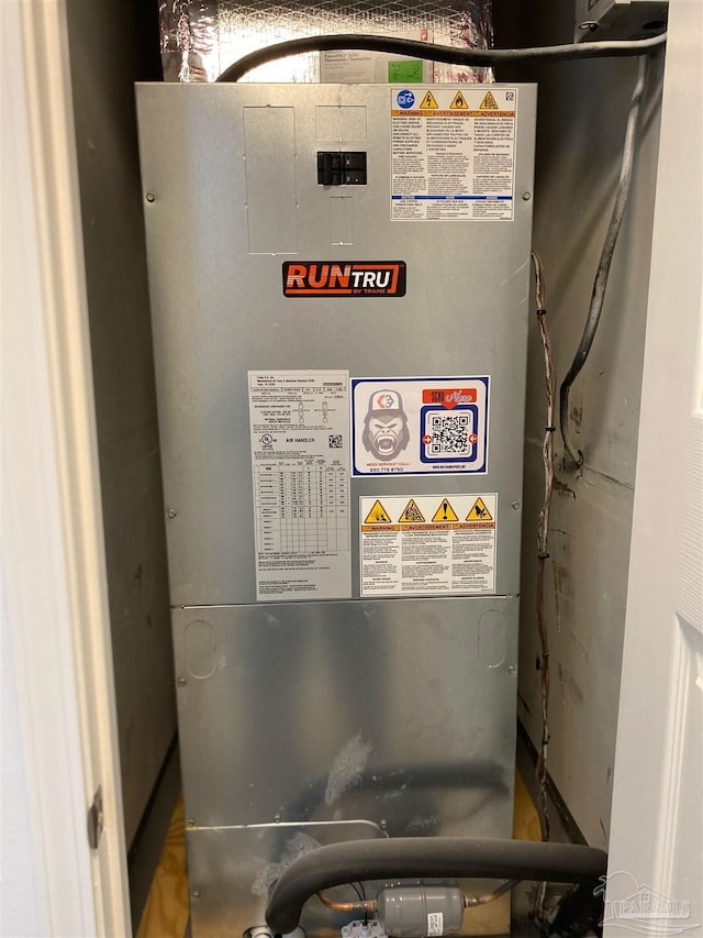 utility room featuring heating unit