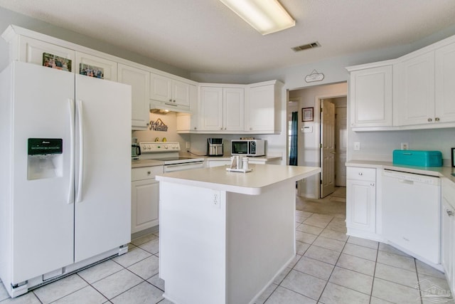 kitchen featuring white cabinetry, light tile patterned floors, white appliances, and a center island