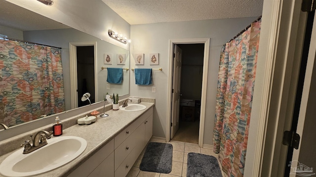 bathroom featuring tile patterned floors, a shower with shower curtain, a textured ceiling, and vanity