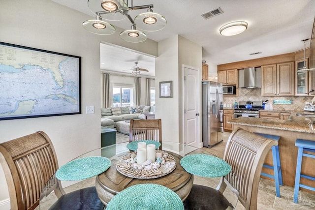 dining space featuring visible vents, baseboards, and ceiling fan