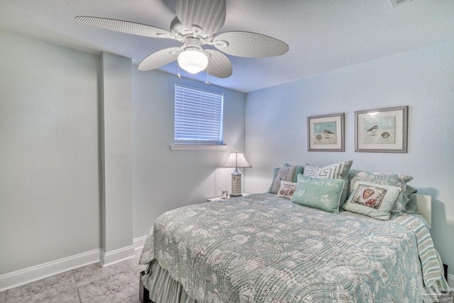 bedroom with baseboards and ceiling fan