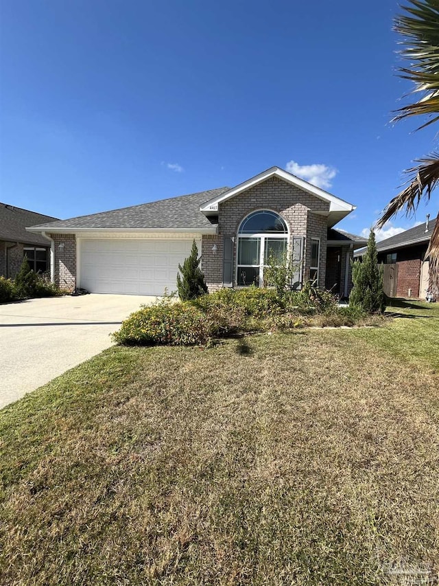 ranch-style house featuring a garage and a front yard