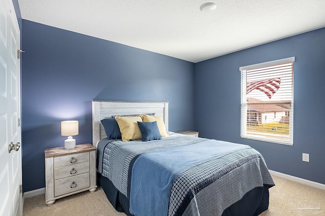 carpeted bedroom with a textured ceiling