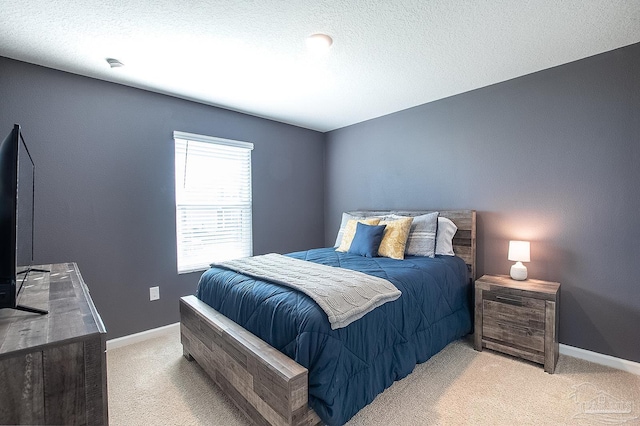 carpeted bedroom featuring a textured ceiling