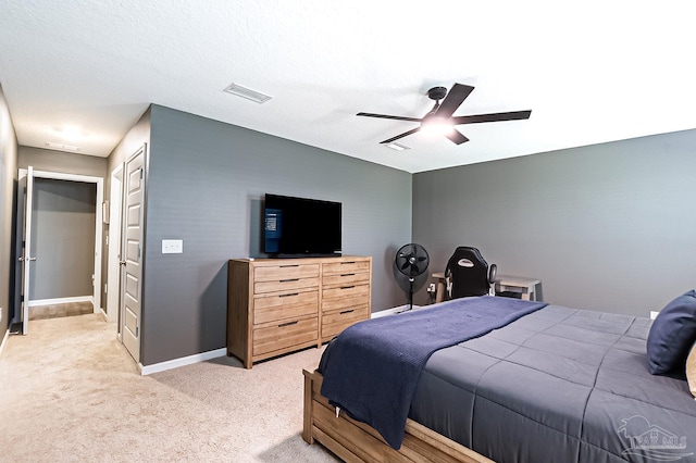 carpeted bedroom featuring ceiling fan, a textured ceiling, and a closet