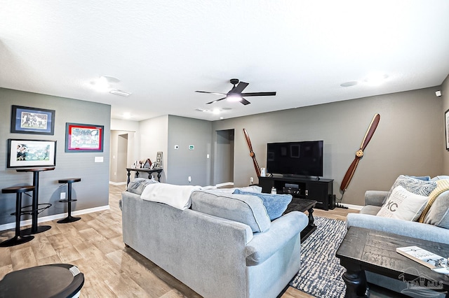 living room with ceiling fan and light hardwood / wood-style flooring