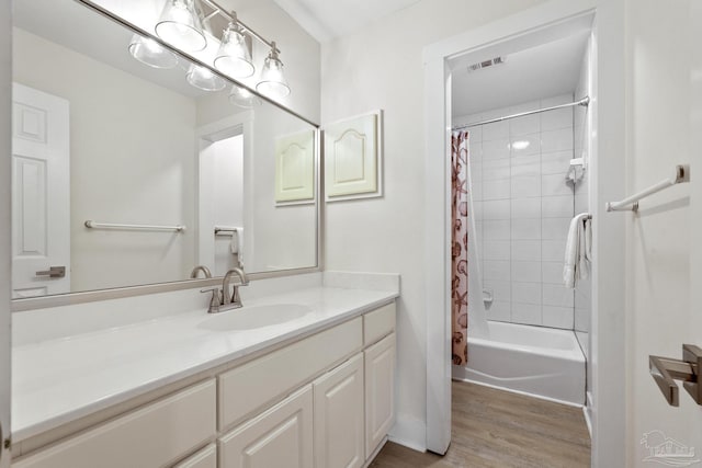 bathroom with hardwood / wood-style floors, vanity, and shower / tub combo with curtain