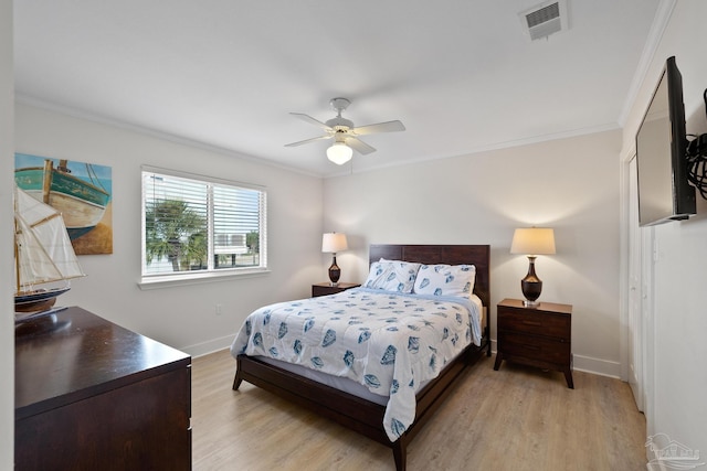 bedroom featuring light wood-type flooring, ceiling fan, and crown molding