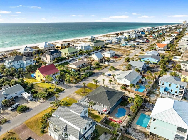 birds eye view of property featuring a beach view and a water view