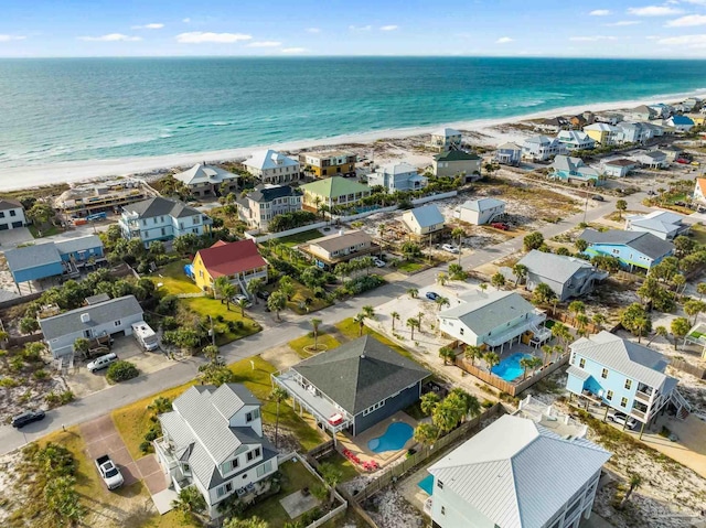 bird's eye view featuring a water view and a beach view