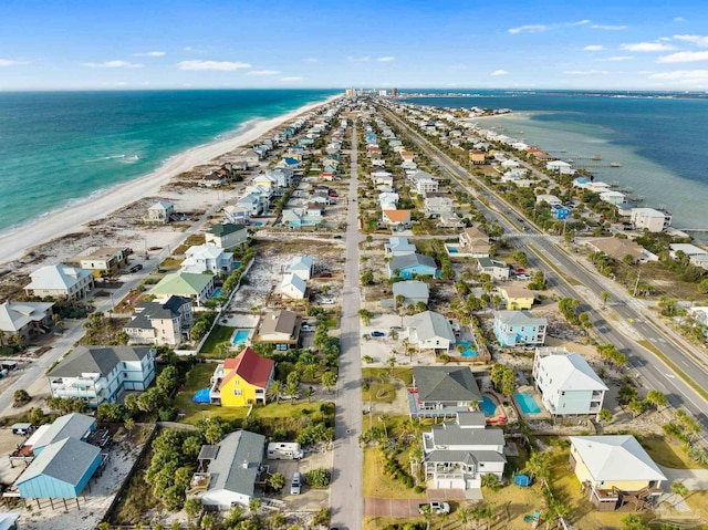 bird's eye view featuring a water view and a beach view