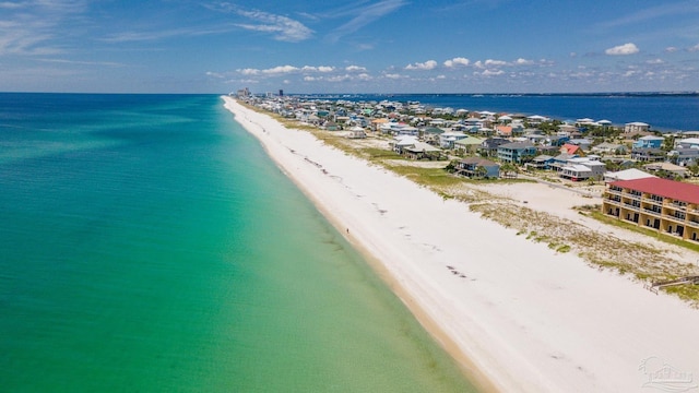 birds eye view of property with a water view and a view of the beach