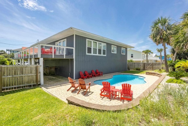 back of house with a fenced in pool and a patio area