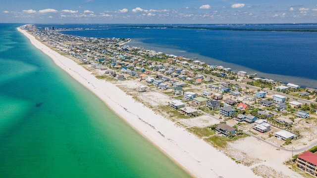 aerial view with a water view and a beach view