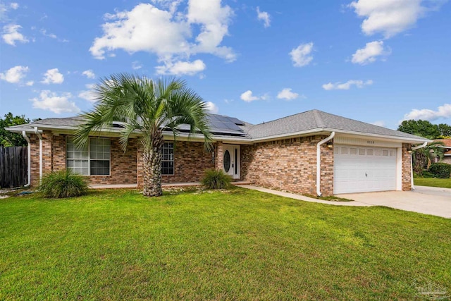 ranch-style house featuring a front lawn, a garage, and solar panels