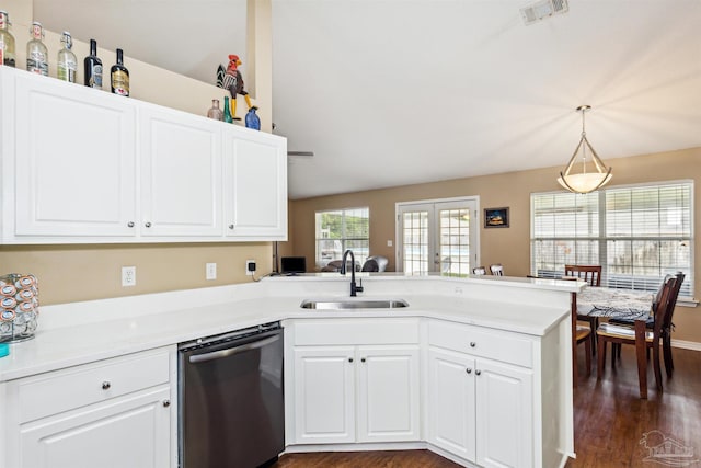 kitchen with sink, stainless steel dishwasher, dark hardwood / wood-style floors, kitchen peninsula, and pendant lighting