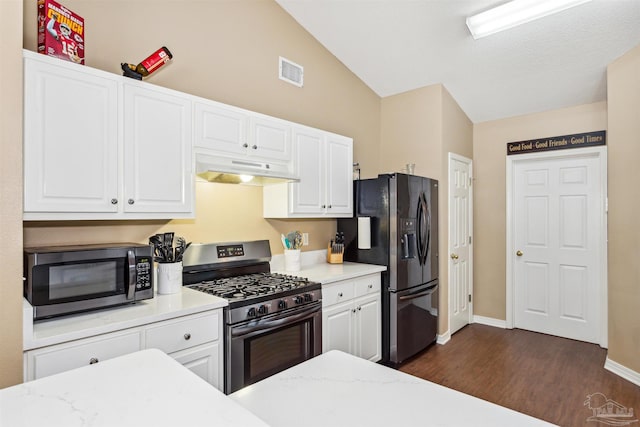 kitchen with light stone countertops, appliances with stainless steel finishes, dark hardwood / wood-style flooring, white cabinets, and lofted ceiling