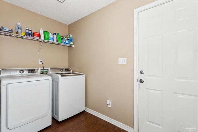 washroom featuring a textured ceiling, dark hardwood / wood-style floors, and washer and clothes dryer