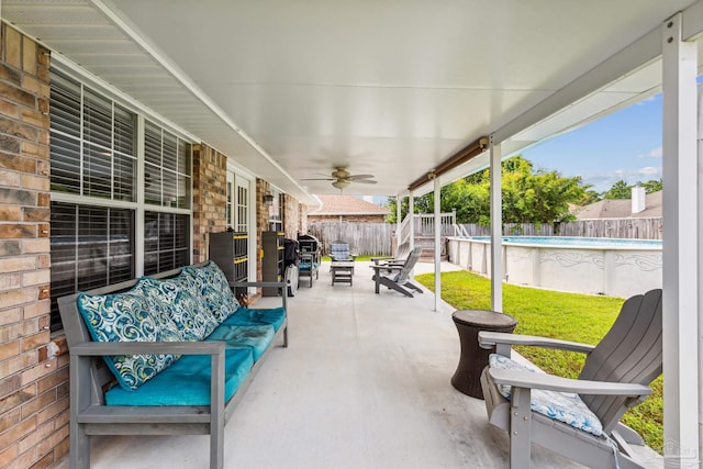 view of patio featuring outdoor lounge area, a fenced in pool, and ceiling fan