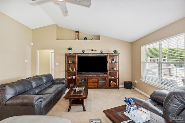 carpeted living room with ceiling fan and vaulted ceiling