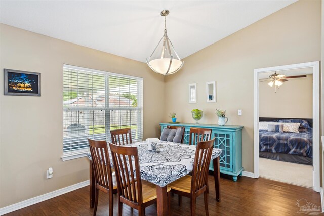 dining room featuring ceiling fan, dark hardwood / wood-style flooring, and vaulted ceiling