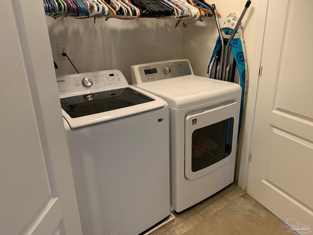 clothes washing area featuring independent washer and dryer and light tile patterned floors