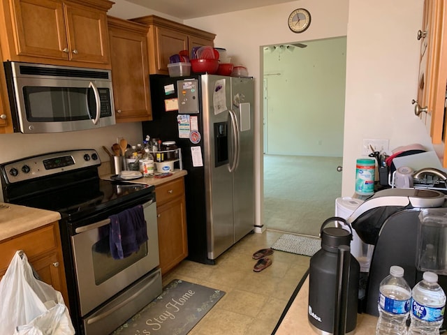 kitchen with stainless steel appliances and light tile patterned floors