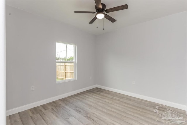 spare room with ceiling fan and light wood-type flooring