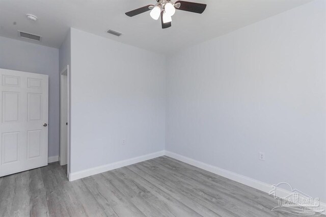 spare room with light hardwood / wood-style flooring and ceiling fan